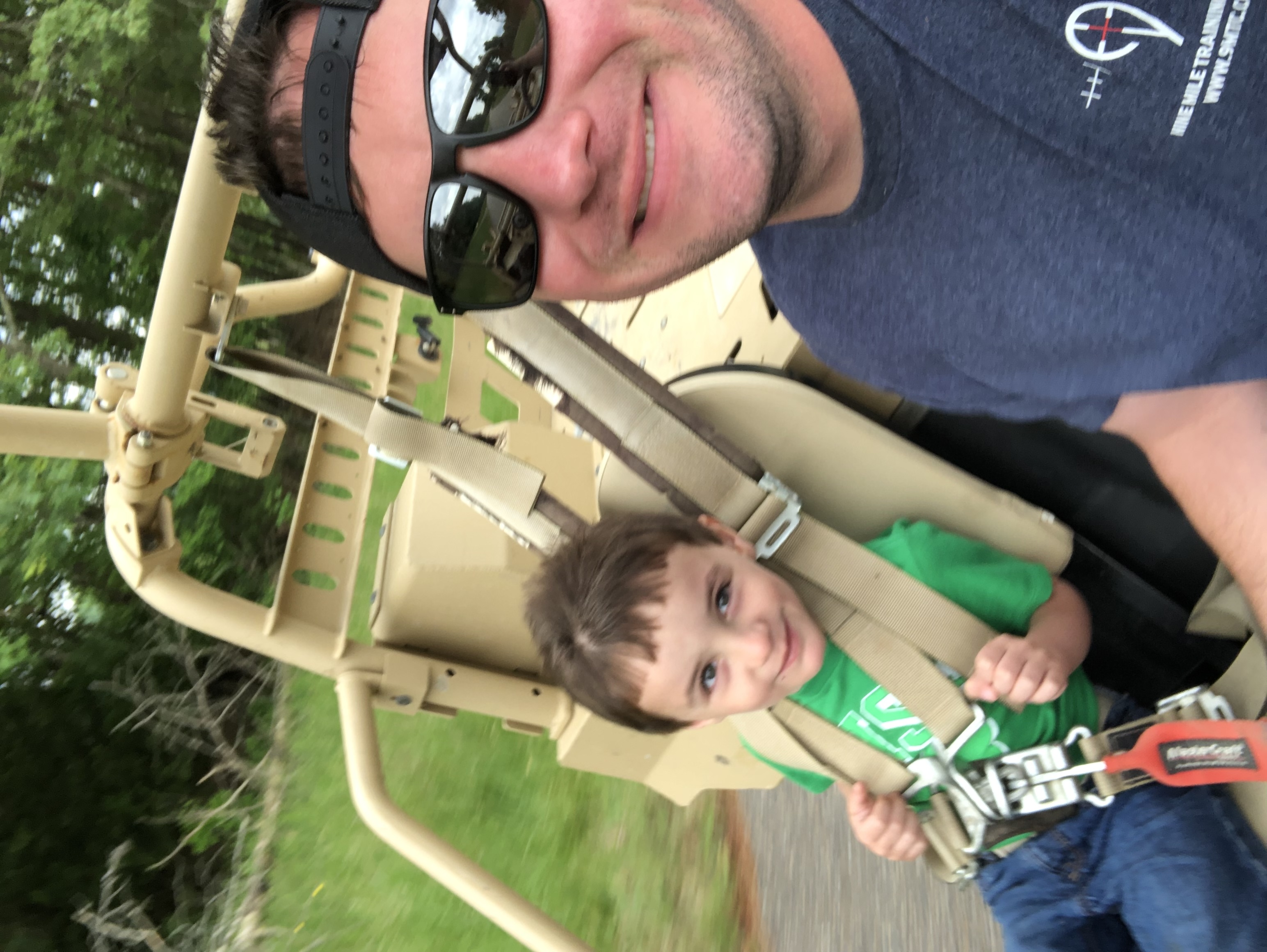 A father and child smiling together on a ride